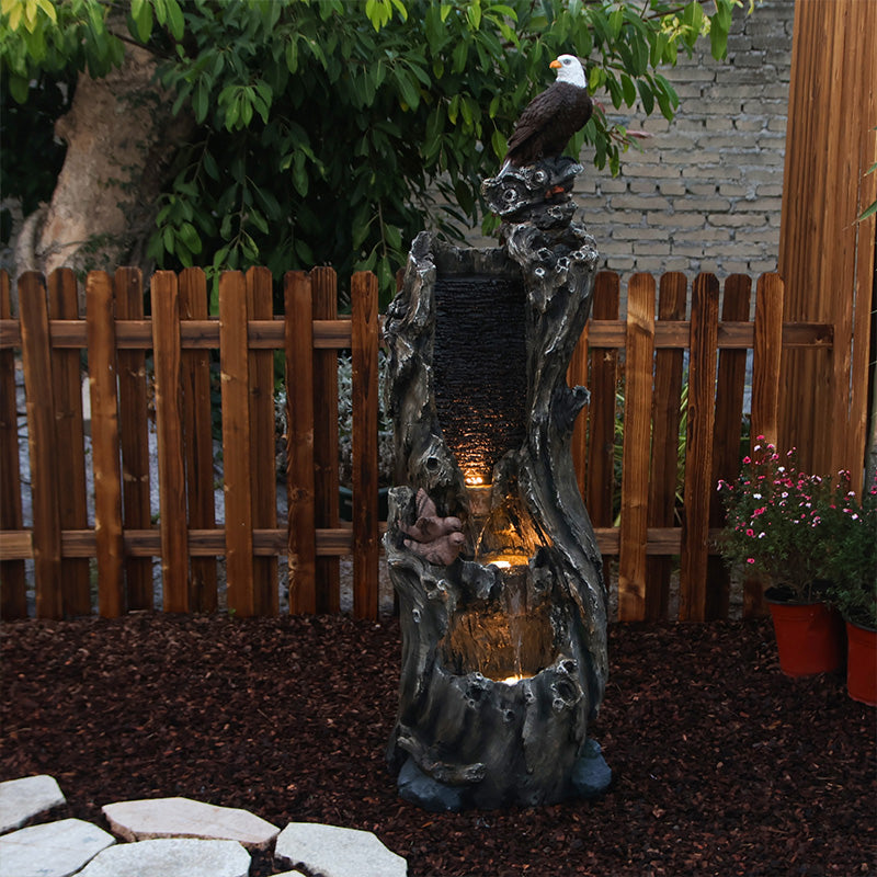 FountJoy Bald Eagle Rainforest Tree Trunk Water Fountain with Warm LED Lights - Soft Illumination Highlighting Eagle and Rainforest Details - Nighttime Backyard Landscape Centerpiece