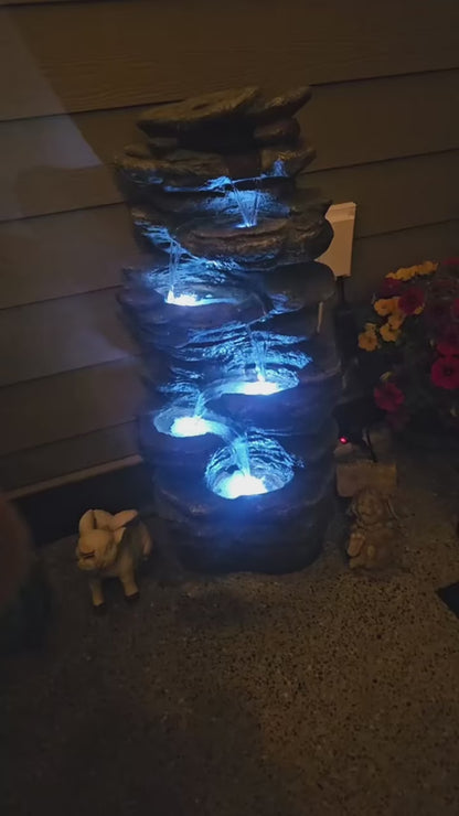 FountJoy 3-Tier Rock Waterfall LED Outdoor Water Fountain featuring natural stone-textured design with multi-level cascading water flow. Integrated LED lighting enhances the waterfall effect, perfect as a backyard fountain or garden yard decoration.