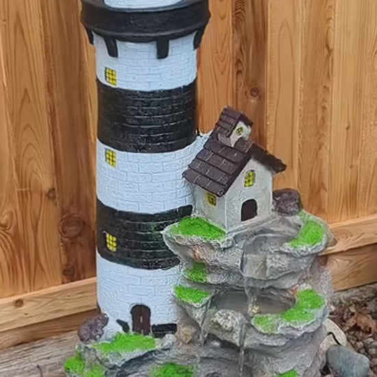 FountJoy 3-Tier Rock Waterfall Lighthouse LED Water Fountain, 38.58 inches tall, polyester resin with unique lighthouse and rock waterfall design. Built-in LED lights illuminate the cascading water, a distinctive outdoor water fountain for garden and yard display.