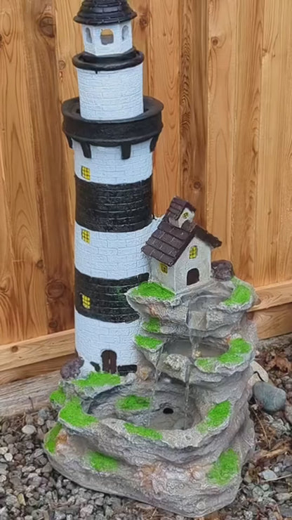 FountJoy 3-Tier Rock Waterfall Lighthouse LED Water Fountain, 38.58 inches tall, polyester resin with unique lighthouse and rock waterfall design. Built-in LED lights illuminate the cascading water, a distinctive outdoor water fountain for garden and yard display.