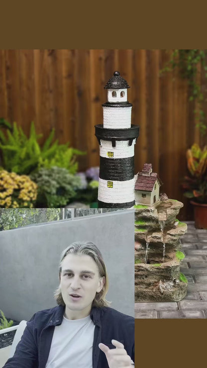 FountJoy lighthouse fountain bringing coastal charm to your backyard — water cascades over textured rocks past a charming lighthouse while LED lights create a magical nighttime glow. A conversation-starting garden fountain for any patio setting.