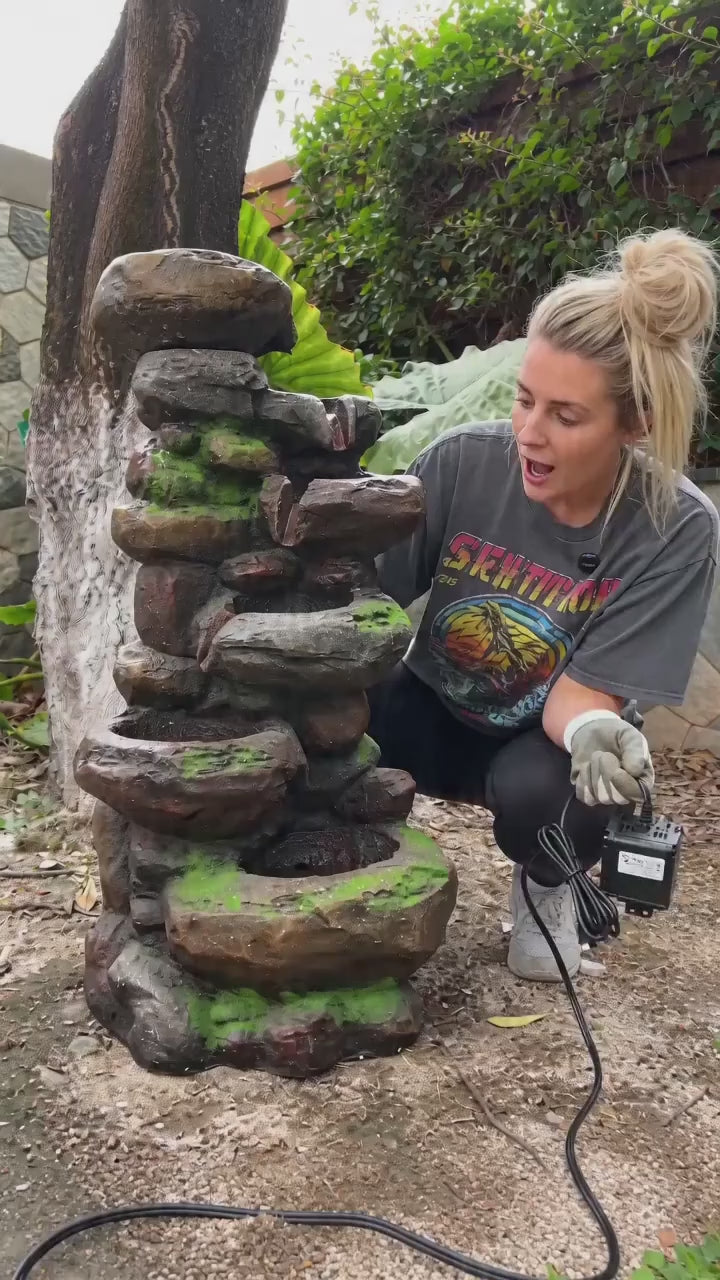 FountJoy rock waterfall fountain recreating the beauty of nature in your own garden. Listen to water tumbling over layered stone tiers as LED lights cast a warm glow — transform your patio into a peaceful retreat with this outdoor water feature.